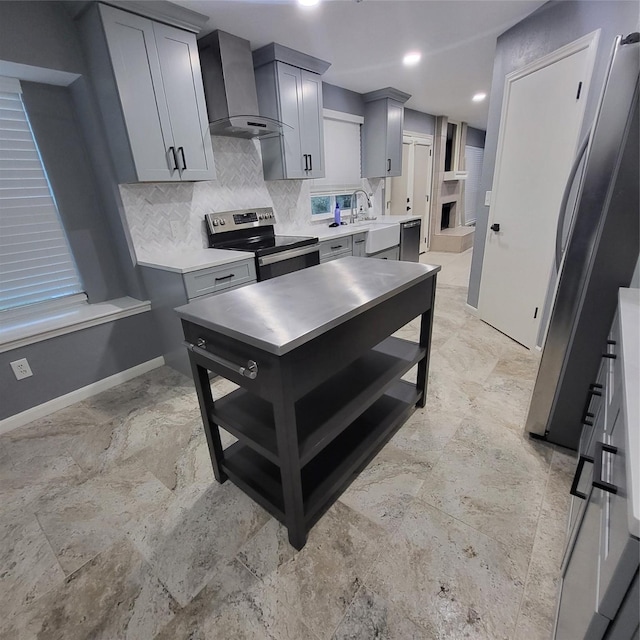 kitchen with gray cabinetry, sink, wall chimney range hood, tasteful backsplash, and stainless steel range with electric stovetop