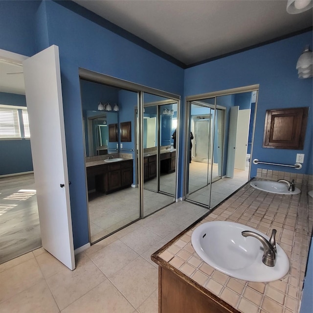 bathroom featuring tile patterned flooring and vanity