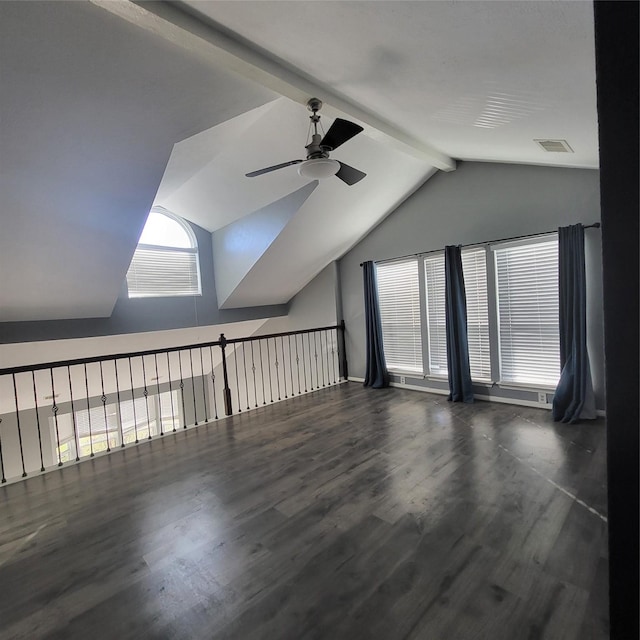 additional living space featuring vaulted ceiling with beams, ceiling fan, and dark hardwood / wood-style floors