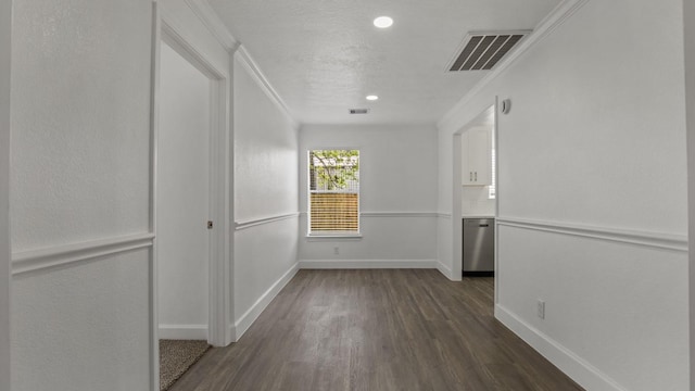 interior space with dark wood-type flooring and ornamental molding