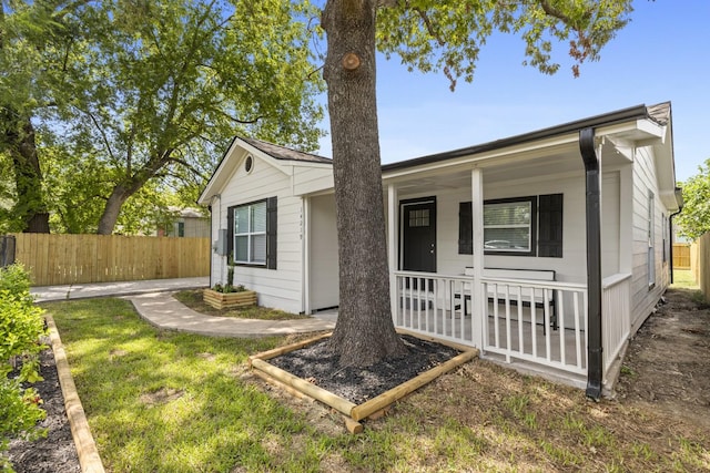 single story home featuring covered porch