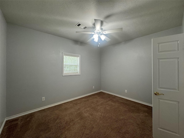 unfurnished room with dark colored carpet, ceiling fan, and a textured ceiling