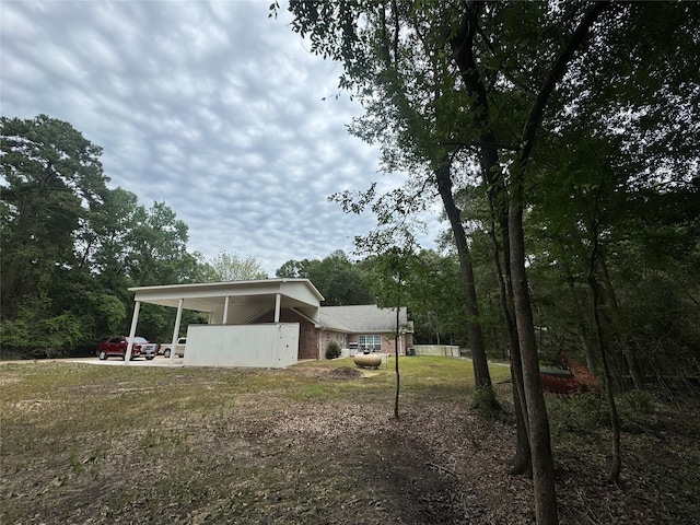 exterior space featuring a front yard and a carport