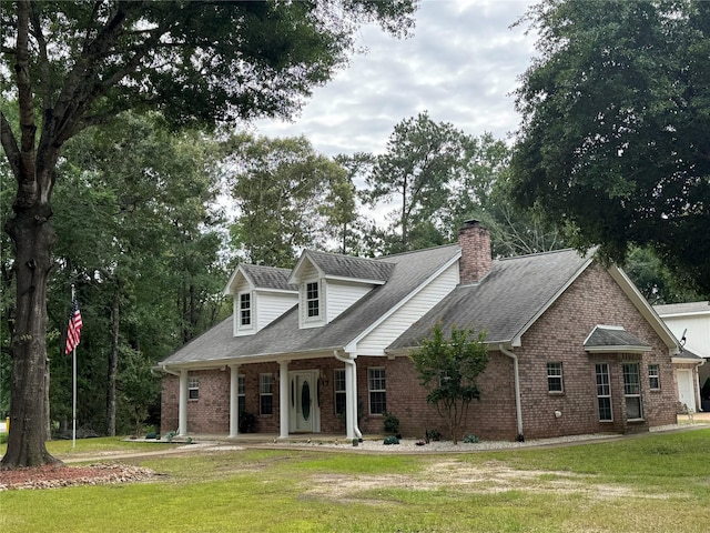 new england style home with a front lawn