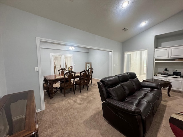 carpeted living room with lofted ceiling