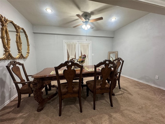 dining space featuring carpet floors and ceiling fan