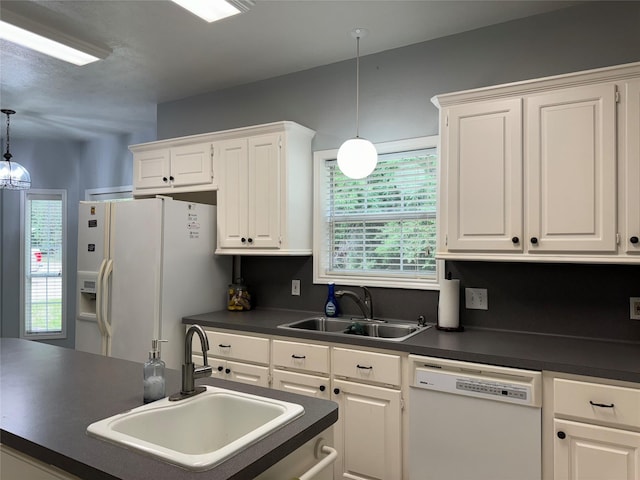 kitchen with white cabinets, white appliances, sink, and hanging light fixtures