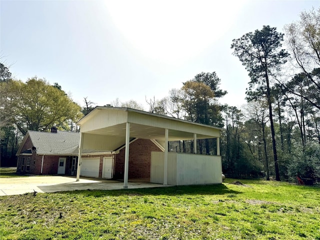 17 Cottonwood Rd, Trinity, TX 75862 - view of home's exterior with a lawn, brick siding, and concrete driveway