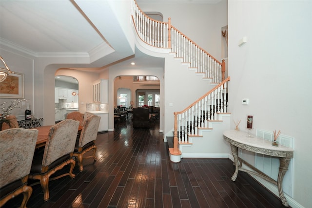 entryway with wood-type flooring and ornamental molding