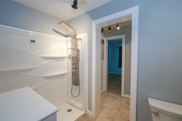 bathroom featuring a shower and toilet