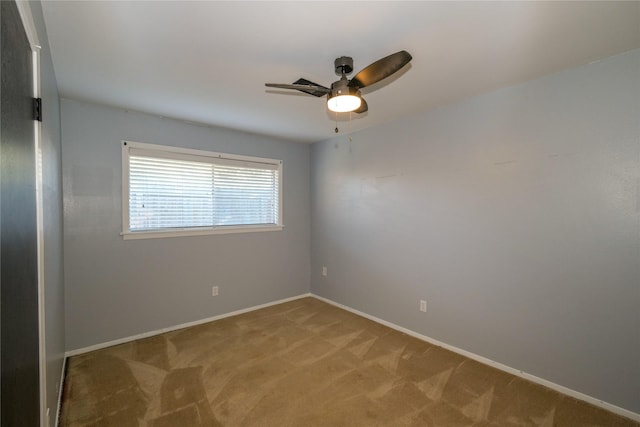 spare room featuring ceiling fan and light carpet