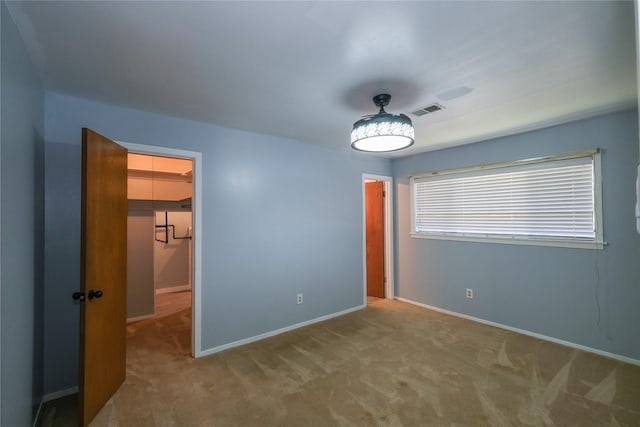 unfurnished bedroom with light colored carpet