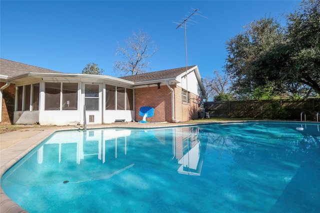 view of pool featuring a sunroom