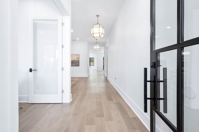 corridor with light hardwood / wood-style flooring