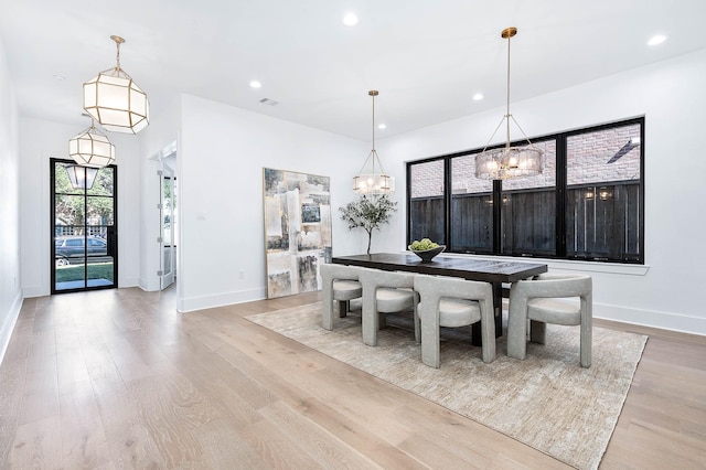 dining space with light hardwood / wood-style flooring