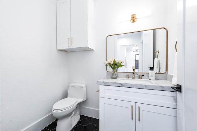 bathroom featuring tile patterned floors, vanity, and toilet