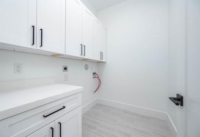 laundry room featuring cabinets, washer hookup, and electric dryer hookup