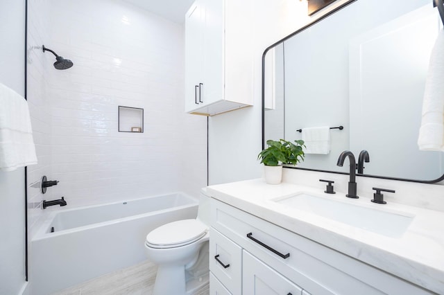 full bathroom with hardwood / wood-style floors, vanity, toilet, and tiled shower / bath