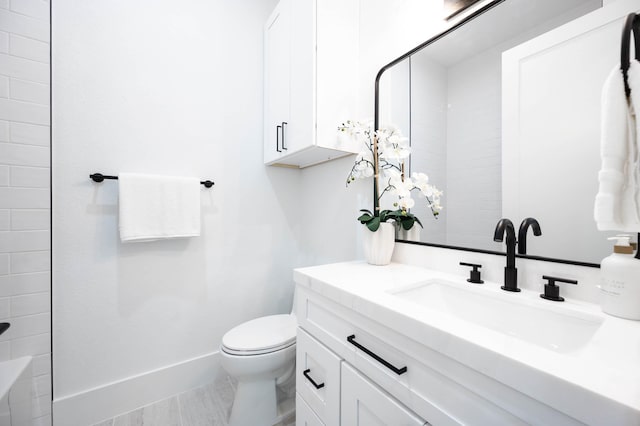 bathroom with tile patterned floors, vanity, and toilet