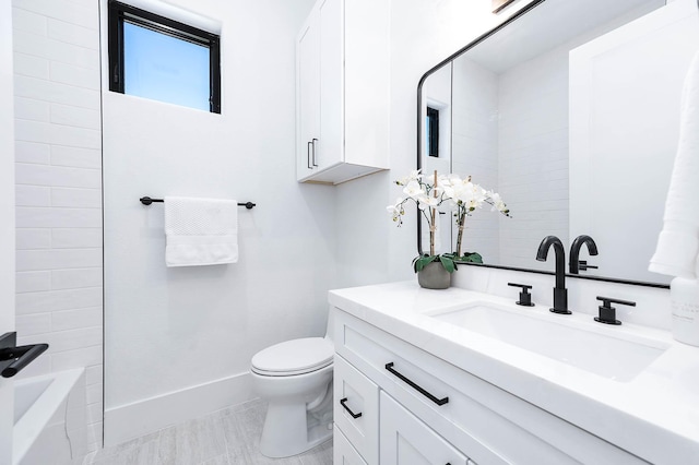 bathroom featuring tile patterned flooring, vanity, and toilet