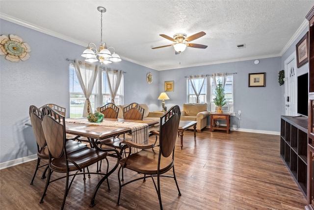 dining space featuring a textured ceiling, ceiling fan with notable chandelier, dark hardwood / wood-style floors, and crown molding