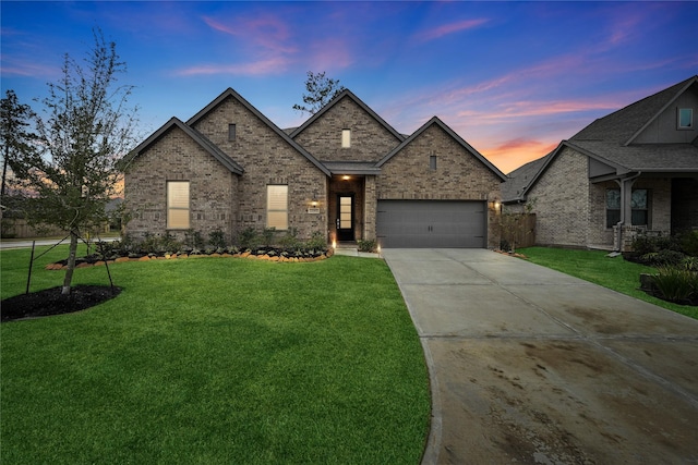 view of front facade with a yard and a garage