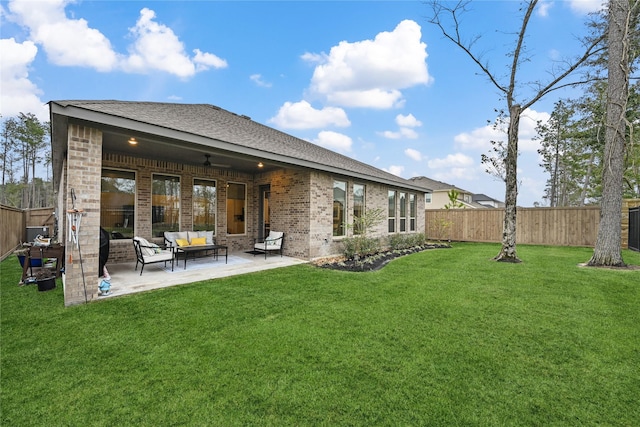 back of property with ceiling fan, an outdoor hangout area, and a yard