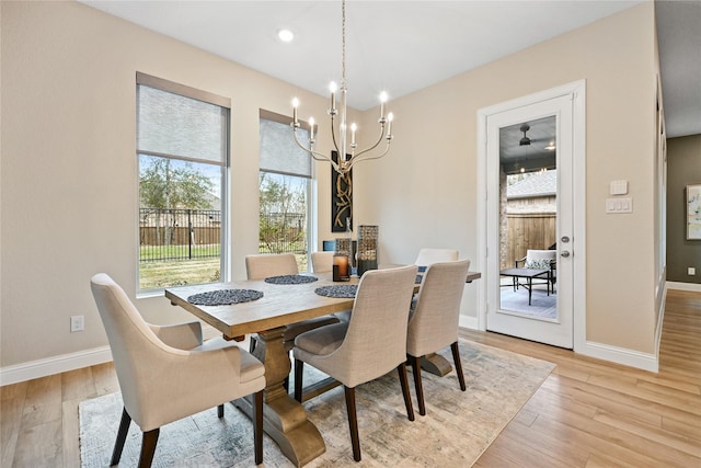 dining room featuring an inviting chandelier and light hardwood / wood-style flooring