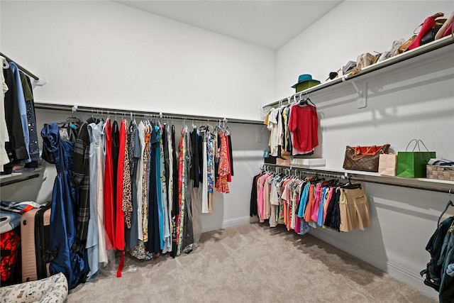 spacious closet featuring light colored carpet