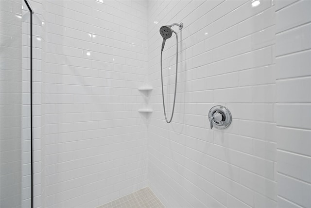 bathroom with tiled shower