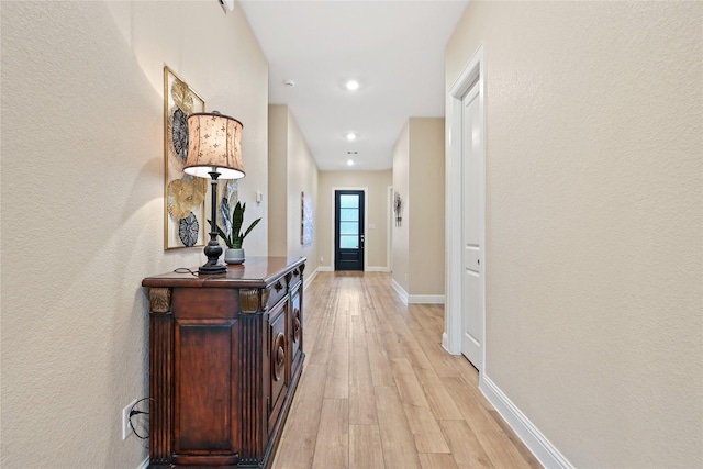 corridor featuring light hardwood / wood-style floors