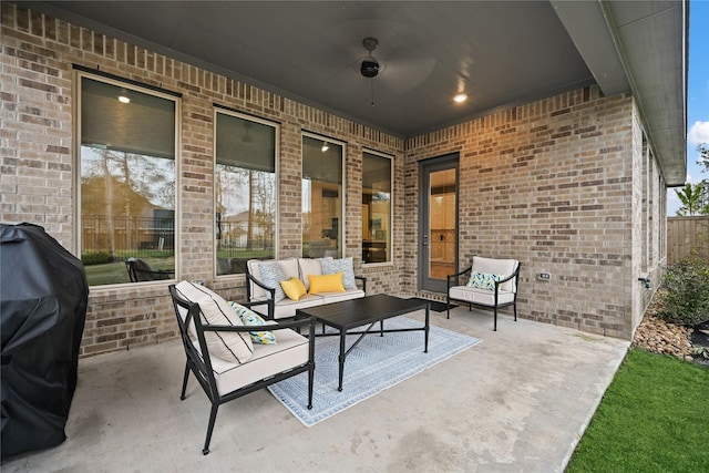 view of patio with an outdoor living space, area for grilling, and ceiling fan