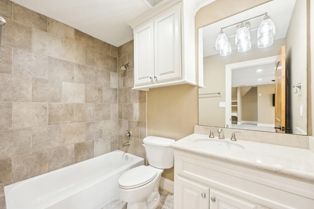 full bathroom with tiled shower / bath, vanity, and toilet