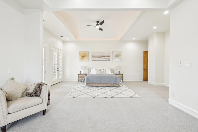 bedroom with access to outside, light colored carpet, a raised ceiling, and ceiling fan