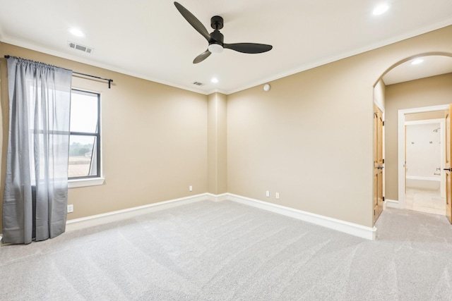 carpeted empty room with crown molding and ceiling fan