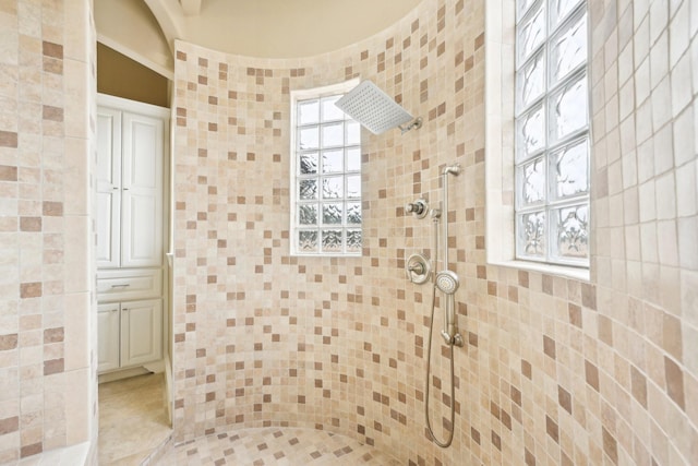 bathroom featuring tiled shower and a healthy amount of sunlight