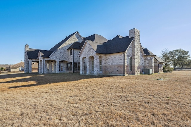 view of front facade featuring a front yard and central AC unit