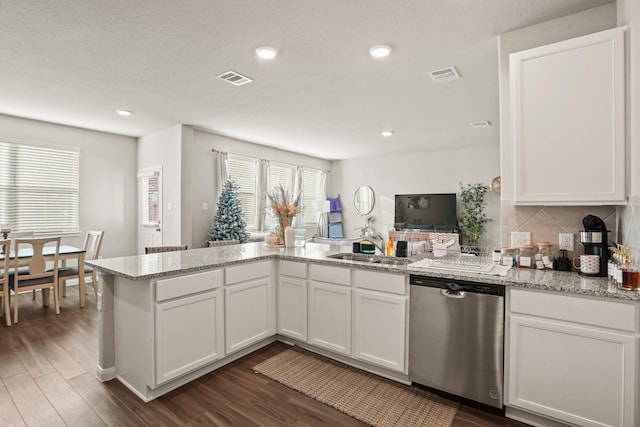 kitchen featuring dishwasher and white cabinetry