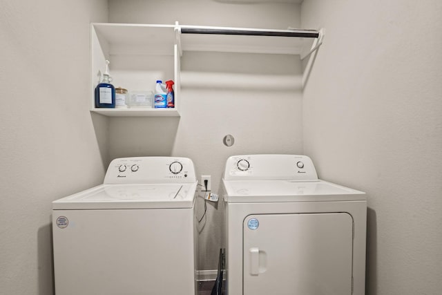 clothes washing area with washer and clothes dryer