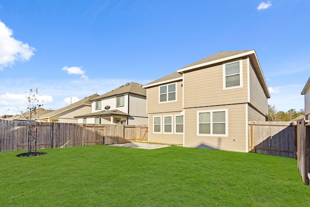 rear view of property featuring a yard