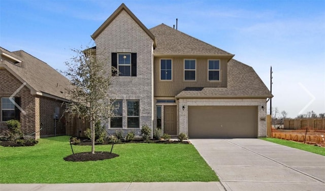 view of front of home featuring a front yard and a garage