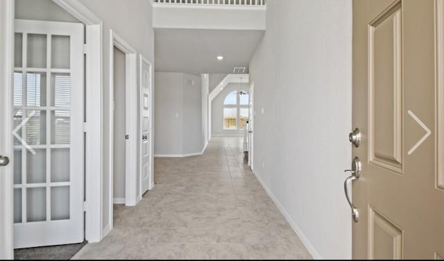 hall featuring light tile patterned floors