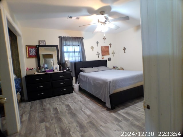 bedroom with hardwood / wood-style flooring and ceiling fan