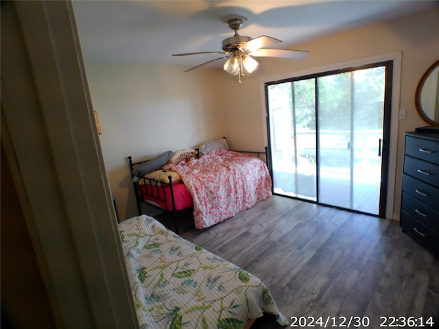 bedroom with access to outside, dark hardwood / wood-style floors, and ceiling fan