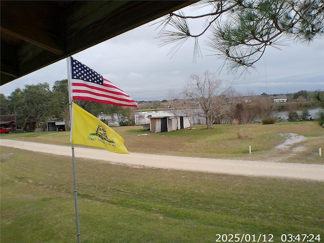 exterior space featuring a yard and a shed