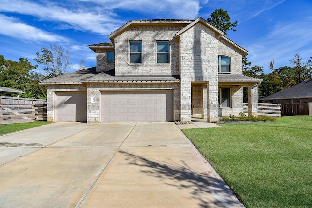 view of front of house featuring a garage and a front lawn