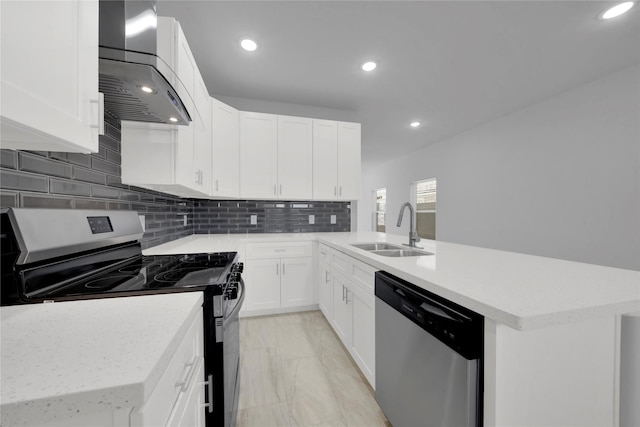 kitchen with wall chimney range hood, stainless steel appliances, white cabinetry, and sink