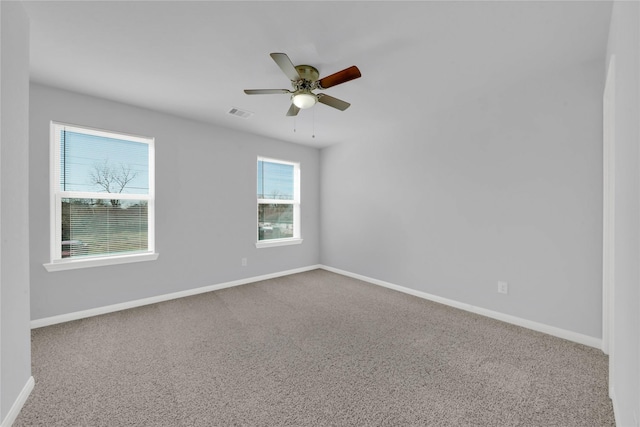 carpeted spare room with ceiling fan