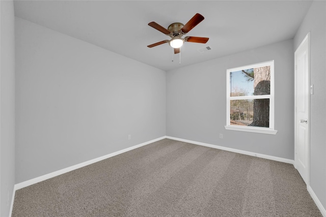 carpeted spare room with ceiling fan