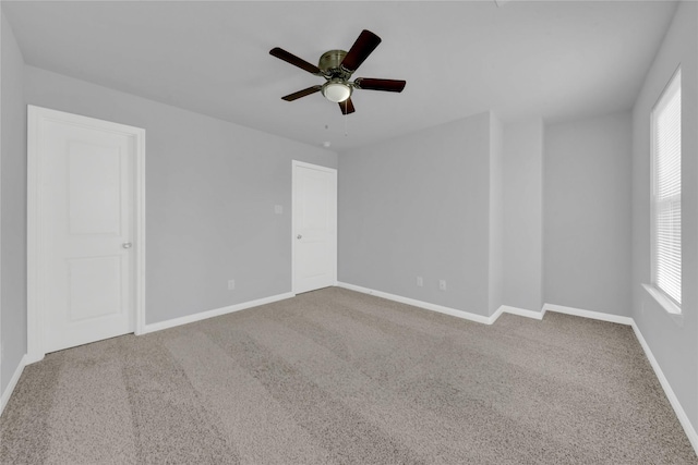 spare room with carpet flooring and ceiling fan